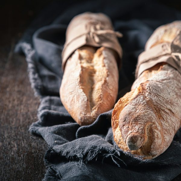 Brown baguettes for healthy breakfast. Country kitchen or bakery.